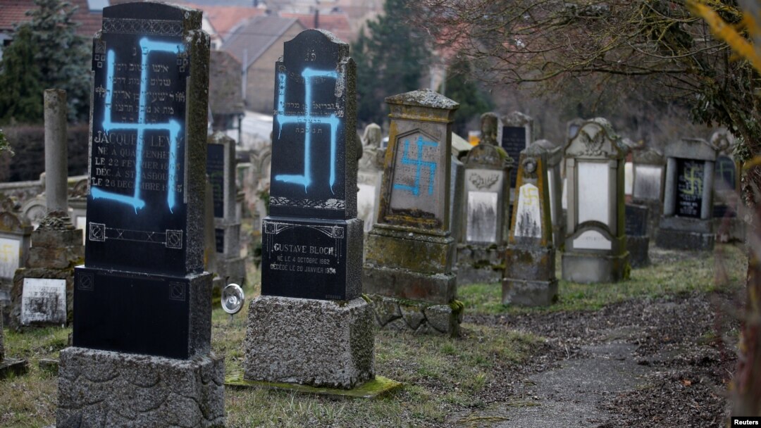 Simbol swastika terlihat pada beberapa batu nisan di pemakaman Yahudi di Quatzenheim, dekat Strasbourg, 19 Februari 2019.