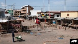 A man walks through an empty market in Old Market Road in Onitsha on May 30, 2017, during a shutdown in commemoration of the 50th anniversary of the Nigerian Civil War. 