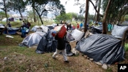 Venezuelan migrants camp in a park near the main bus terminal in Bogota, Colombia, Sept. 7, 2018.