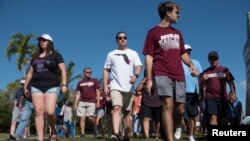 Students and parents arrive for voluntary campus orientation at the Marjory Stoneman Douglas High School, for the coming Wednesday's reopening, following last week's mass shooting in Parkland, Florida, Feb. 25, 2018. 