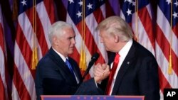 Presiden terpilih Amerika, Donald Trump (kanan) berjabat tangan dengan wapres terpilih, Mike Pence sesaat sebelum menyampaikan pidato kemenangannya di New York, 9 November 2016 (AP Photo/John Locher).