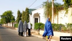 Women walk in a street in a residential area in Maiduguri, Borno State May 19, 2013, an area where President Goodluck Jonathan has declared a state of emergency.