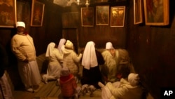 FILE - Christian pilgrim worshippers from Nigeria pray in the Grotto of the Church of Nativity in the West Bank town of Bethlehem on Christmas Eve, Dec. 24, 2013.