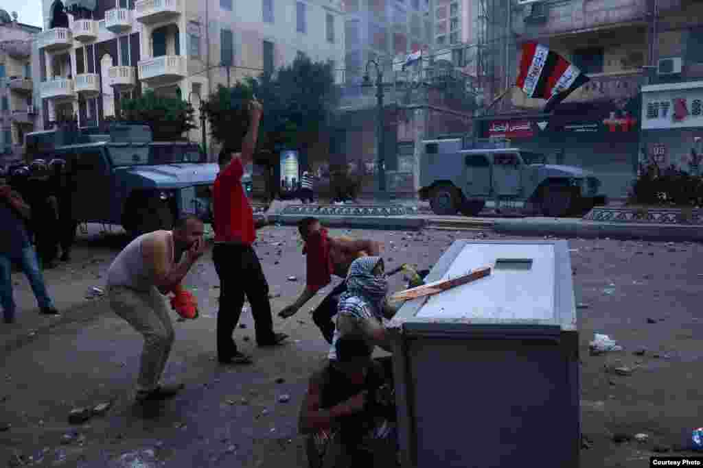 Photographers in Alexandria say they are blamed for the increasingly one-sided news. Some say they will change who they say they are shooting for based on the political views of the crowd, August 2013. (Courtesy of Amira Mortada) 