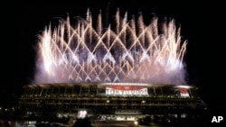 Fireworks illuminate the National Stadium during the opening ceremony of the 2020 Summer Olympics, July 23, 2021, in Tokyo.