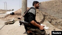 A Free Syrian Army fighter holds his weapon in Raqqa province, east Syria, May 6, 2013. 