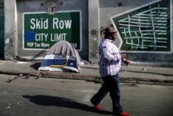 FILE - A man walks on Skid Row in Los Angeles, California, Oct. 14, 2019.