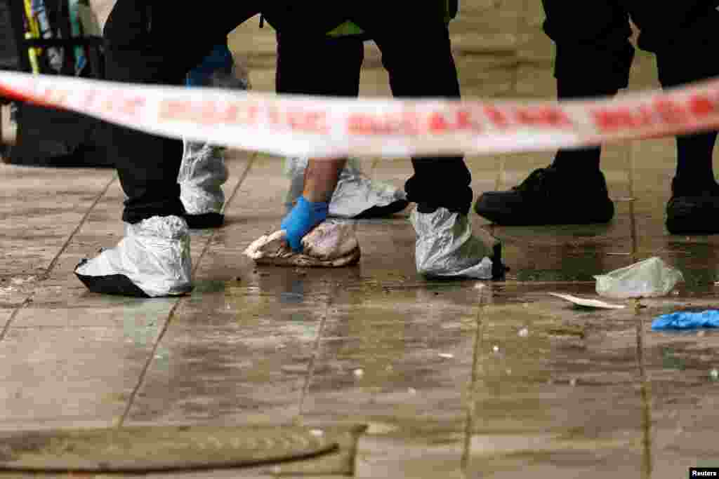 Israeli emergency services employees work at the scene of a suspected attack near Herzliya, Israel.