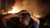 A man looks at a forest fire near the village of Larbaa Nath Irathen, near Tizi Ouzou, in the mountainous Kabyle region, 100 kilometers (60 miles) east of Algeria's capital of Algiers, Aug.11, 2021.