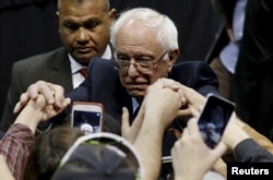 Democratic U.S. presidential candidate Bernie Sanders shakes hands with supporters during a campaign rally at Missouri State University in Springfield, Mo., March 12, 2016.