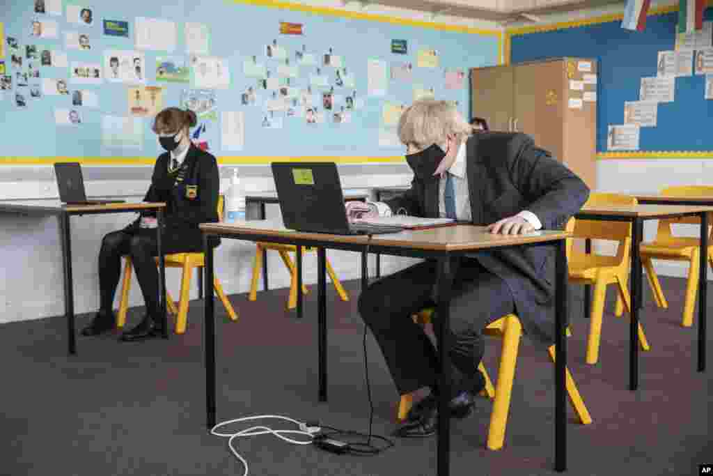 Britain&#39;s Prime Minister Boris Johnson takes part in an online class during a visit to Sedgehill School in Lewisham, south east London, to see preparations for students returning to school.