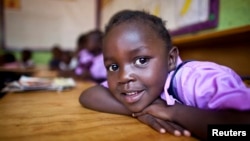 FILE - A four-year-old deaf student sits inside her classroom in the specialized deaf unit program at the Little Rock Inclusive Early Childhood Development Center in Kenya's capital Nairobi.