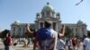 Serbia, Belgrade, A protester raises his fists in front of the Serbian parliament during an anti-government rally