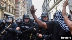 Boston Police officers react as a crowd of counter protesters clashes with them outside of the Boston Commons and the Boston Free Speech Rally in Boston, Massachusetts, Aug. 19, 2017.