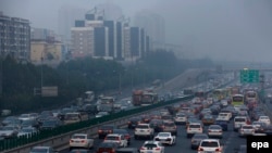 Vehicles go through a main road while the PM2.5 Air Quality Index reaches more than 300 in Beijing, China, October 7, 2015. 
