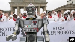People take part in a 'Stop killer robots' campaign at Brandenburg gate in Berlin, Germany, March 21, 2019. 