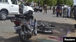 FILE - Security officers are seen standing at the site of a suicide bombing in Ndjamena, Chad, June 15, 2015. Ten men were executed Saturday in connection with this and another attack.