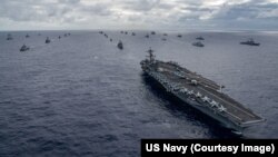 (FILE) Navy ships assemble to form the multinational fleet for a group off the coast of Hawaii during the Rim of Pacific (RIMPAC) exercise on July 26, 2018.