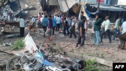 People gather around the site of an explosion at a restaurant in Jhabua district in the central Indian state of Madhya Pradesh, Sept. 12, 2015. 