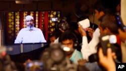 FILE - Indian journalists listen to a video conference of Islamic scholar and the founder of Islamic Research Foundation, Zakir Naik, in Mumbai, India, Friday, July 15, 2016.