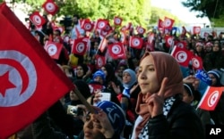 FILE - Tunisians celebrate the fifth anniversary of the Arab Spring, in Tunis, Jan.14, 2016. A new Arab Youth Survey found just five years after the Arab spring, a majority of respondents prioritized stability over democracy in the region.