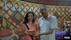 Omorbek Abdiraimov, head of Keremet TV (right), and VOA Uzbek's Navbahor inside a yurt in Kyrgyzstan.