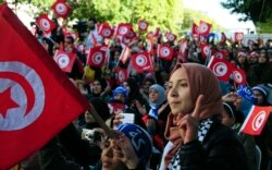 FILE - Tunisians celebrate the fifth anniversary of the Arab Spring, in Tunis, Jan.14, 2016.
