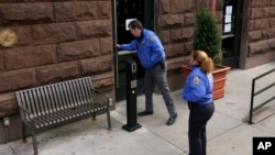 New York Police community affairs officers enter the HI New York City Hostel, Dec. 5, 2024, in New York, where police say the suspect in the killing of UnitedHealthcare CEO Brian Thompson may have stayed.