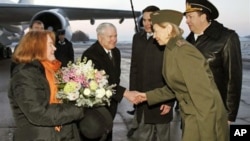 U.S. Defense Secretary Robert Gates, center, and his wife Becky, left, are greeted upon their arrival in St. Petersburg, Russia, March 21, 2011