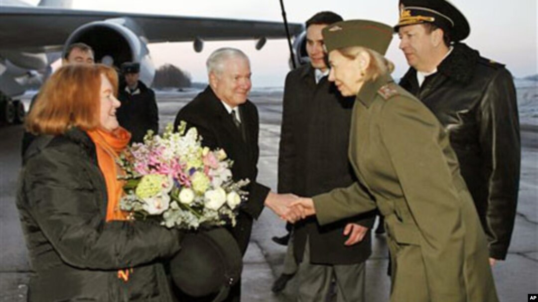 U.S. Defense Secretary Robert Gates, center, and his wife Becky, left, are greeted upon their arrival in St. Petersburg, Russia, March 21, 2011