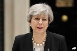 British Prime Minister Theresa May addresses the media outside 10 Downing Street, London, May 23, 2017, the day after an apparent suicide bomber attacked an Ariana Grande concert as it ended Monday night.