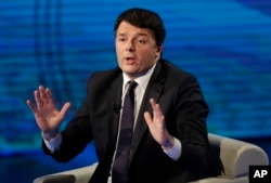 FILE - Former Italian prime minister Matteo Renzi gestures during a TV program, in Milan, Italy, Feb. 26, 2017.