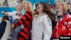 U.S. President Donald Trump's daughter and senior White House adviser Ivanka Trump holds Luke Shuster, son of skip John Shuster of the U.S., next to athletes Cory Christensen and Rebecca Hamilton during the men's final. The U.S. upset Sweden to win the gold.