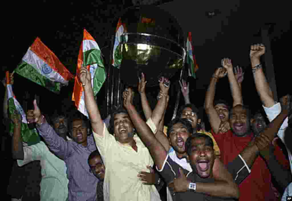 Cricket fans celebrate after India won the ICC Cricket World Cup semi-final match against Pakistan, in the southern Indian city of Hyderabad, March 30, 2011.