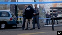 FILE - Law enforcement officials stand outside the Jewish Children's Museum following a bomb threat in Brooklyn, New York, March 9, 2017.