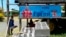 In this Nov. 7, 2018, photo, a FijiFirst poster with the image of Fiji Prime Minister Frank Bainimarama is displayed at the entrance to a village in Nausori, Fiji. 