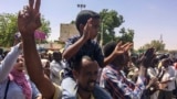 Protesters rally at a demonstration near the military headquarters, April 9, 2019, in the capital Khartoum, Sudan.