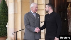 Britain's King Charles and Ukrainian President Volodymyr Zelenskiy shake hands as they meet at the Sandringham Estate in Norfolk, Britain March 2, 2025. 