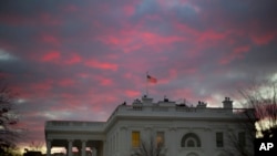 FILE - In this Jan. 27, 2017, photo, day breaks over the White House in Washington. Two weeks into his presidency, Donald Trump has thrown Washington into a state of anxious uncertainty.