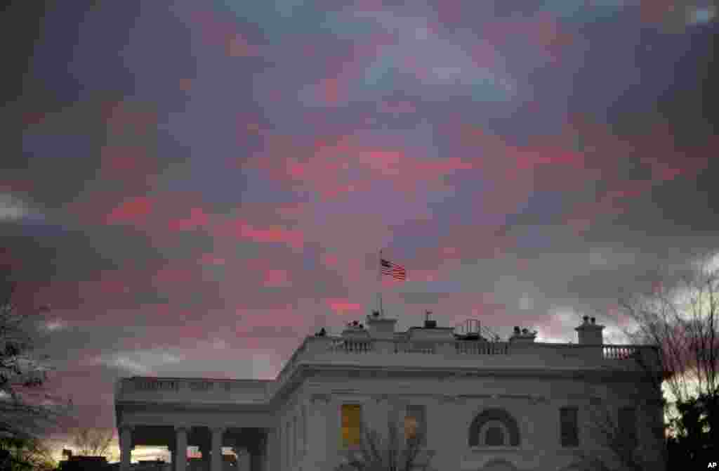 FILE - In this Jan. 27, 2017, photo, day breaks over the White House in Washington. Two weeks into his presidency, Donald Trump has thrown Washington into a state of anxious uncertainty.