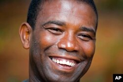 FILE - Senate candidate Guy Philippe smiles during an interview in Pestel, Haiti, Aug. 24, 2016.