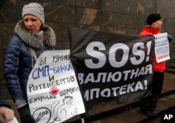 FILE - Hard-currency mortgage holders take part in a protest in front of a bank in St. Petersburg, Russia, Jan. 28, 2016.