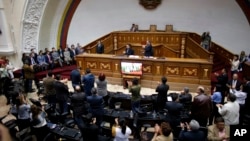 FILE - Members of the diplomatic corps, left , listen as lawmakers applaud during a session of Venezuela's National Assembly in Caracas, Aug. 19, 2017. 