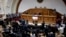 FILE - Members of the diplomatic corps, left , listen as lawmakers applaud during a session of Venezuela's National Assembly in Caracas, Aug. 19, 2017. 