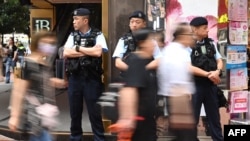 Police keep watch on a street in the Causeway Bay district of Hong Kong on June 4, 2024.