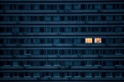 A man is illuminated in an apartment in a building on the outskirts of Moscow on May 4, 2020,during a strict lockdown in Russia to stop the spread of COVID-19 infection.