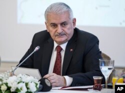 Turkish Prime Minister Binali Yildirim listens during a meeting with journalists in Istanbul, Jan. 21, 2018.