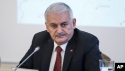 Turkish Prime Minister Binali Yildirim listens during a meeting with journalists in Istanbul, Jan. 21, 2018. 