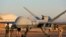 FILE- This photo provided by the French Defense Ministry communication center and taken Tuesday Dec. 17, 2019, shows French soldiers loading a French Reaper drone with two GBU 12 missiles on Niamey airbase, Niger. 