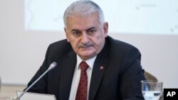 Turkish Prime Minister Binali Yildirim listens during a meeting with journalists in Istanbul, Jan. 21, 2018. 